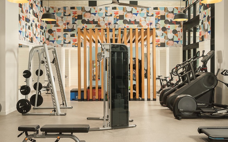 large workout room with lots of equipment
