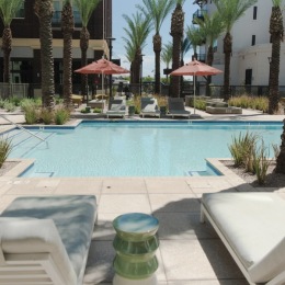 You can find us lounging, swimming, pool area showing reclining seating, wooden coverings and ample space